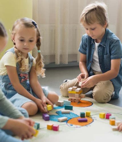 front view children playing together kindergarten